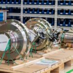 Large industrial valves stored in an organized workshop environment.